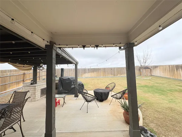a view of a patio with table and chairs a barbeque