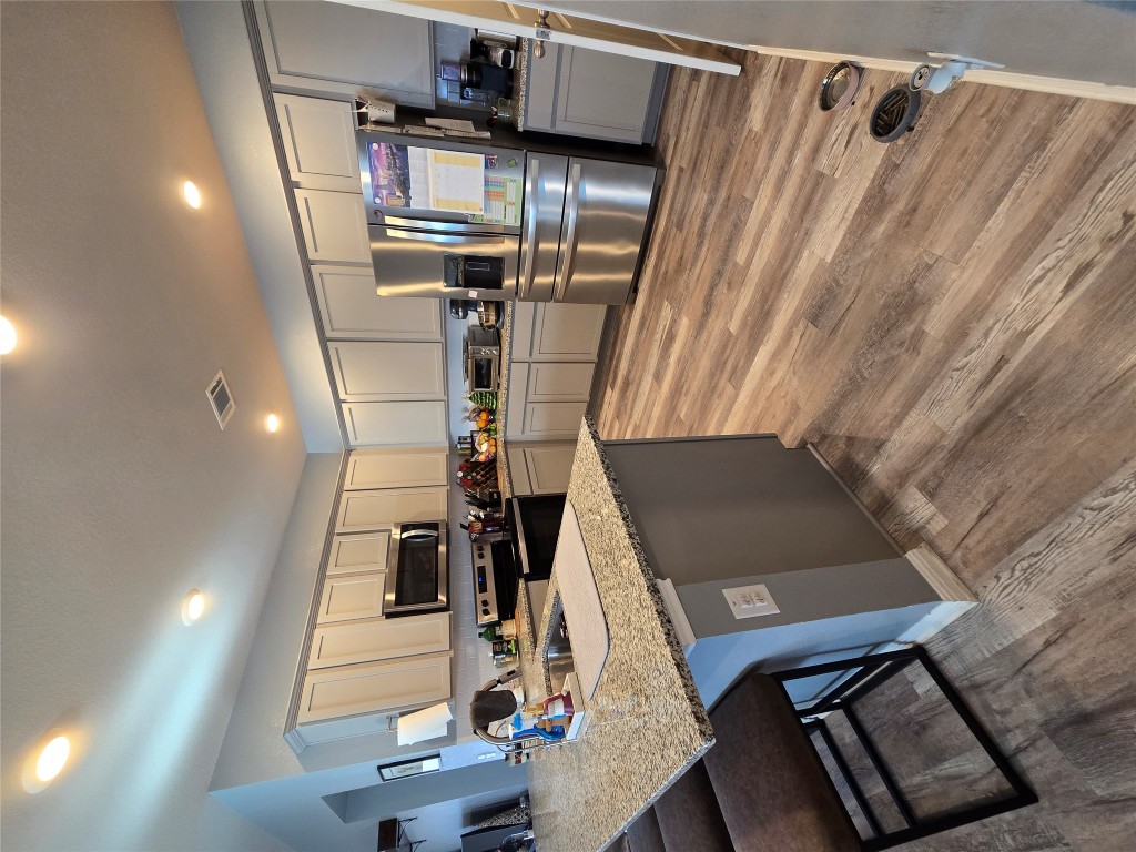444 Hunter Loop Bertram, TX 78605 - Photo 15 of 15 a kitchen with stainless steel appliances granite countertop a sink stove and refrigerator