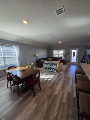 a kitchen with stainless steel appliances kitchen island granite countertop a stove a sink and a microwave