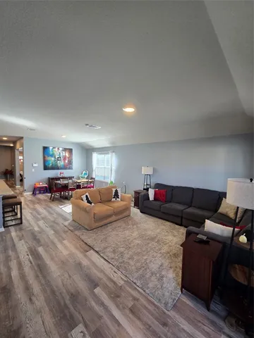 a view of a dining room with furniture and wooden floor