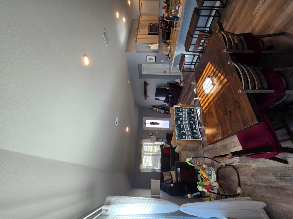 444 Hunter Loop Bertram, TX 78605 - Photo 7 of 15 a living room with furniture a flat screen tv and kitchen view