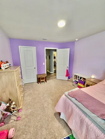 a bedroom with a bed and a table