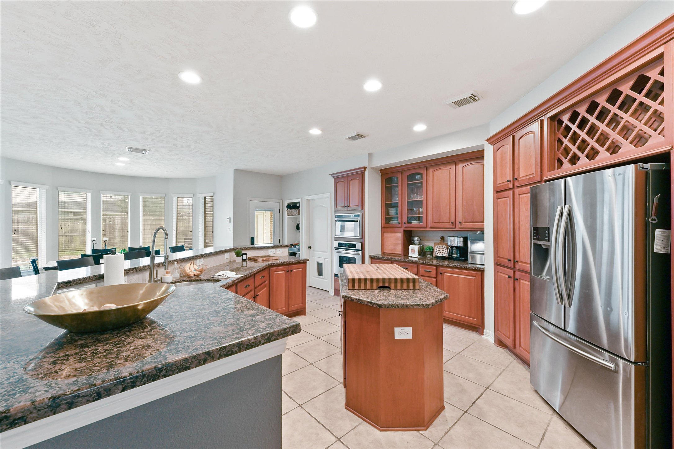 2818 Shallow Springs Court Manvel, TX 77578 - Photo 13 of 41 a kitchen with stainless steel appliances granite countertop a refrigerator a sink and a stove
