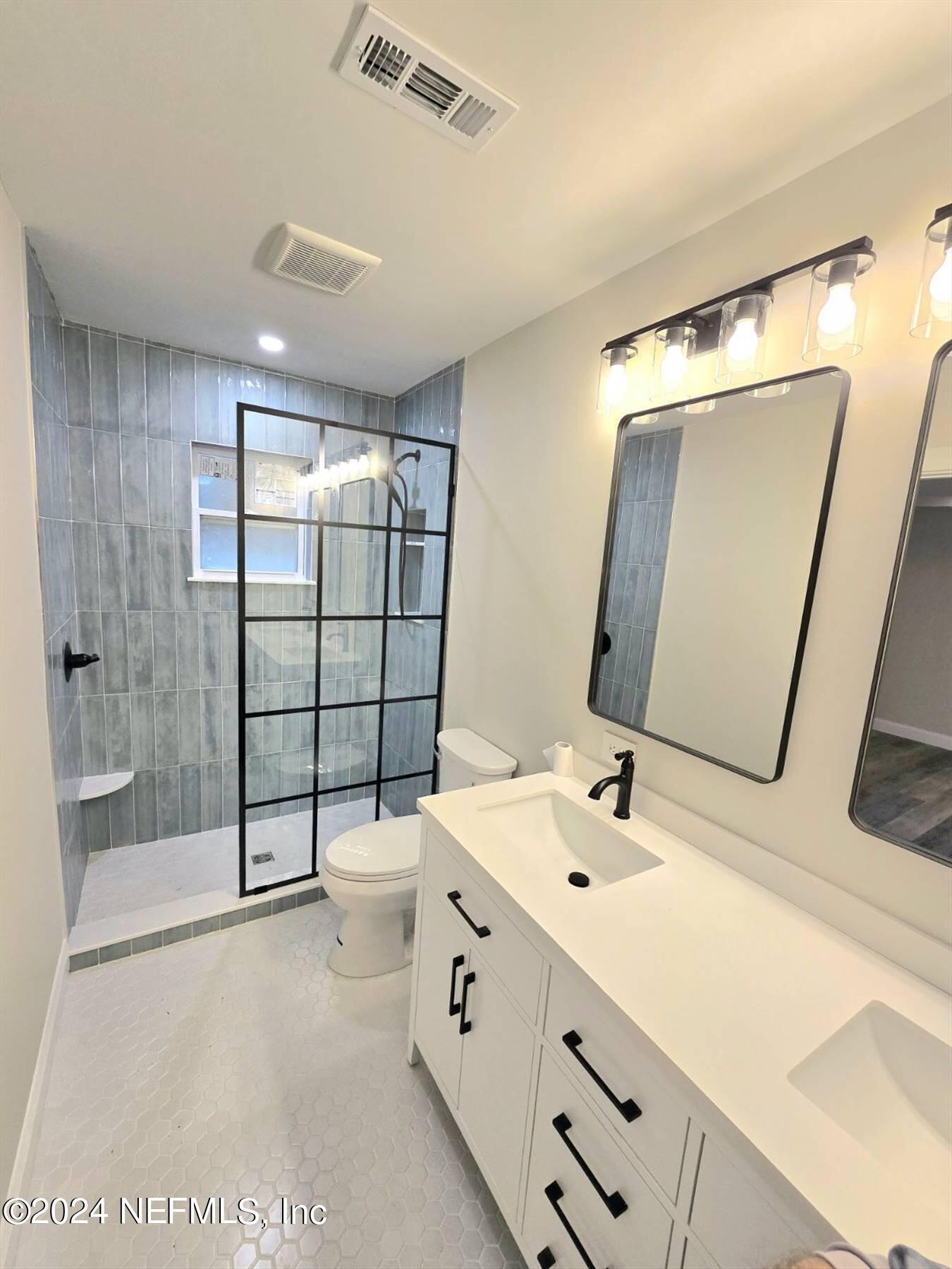 110 Faun Road St. Augustine, FL 32086 - Photo 3 of 4 a bathroom with a double vanity sink toilet and shower