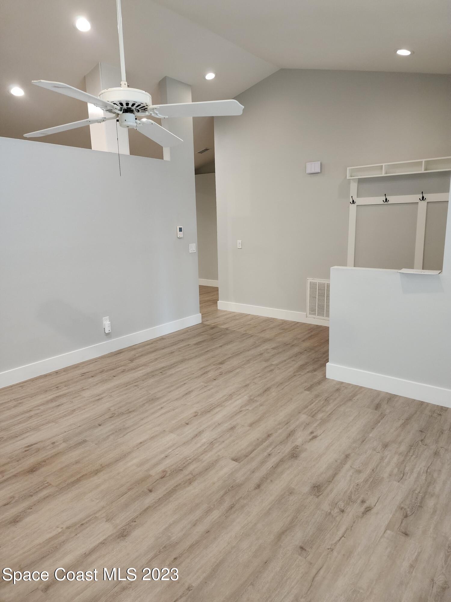 708 Fishtail Palm Boulevard Melbourne, FL 32901 - Photo 13 of 33 a view of an empty room with wooden floor