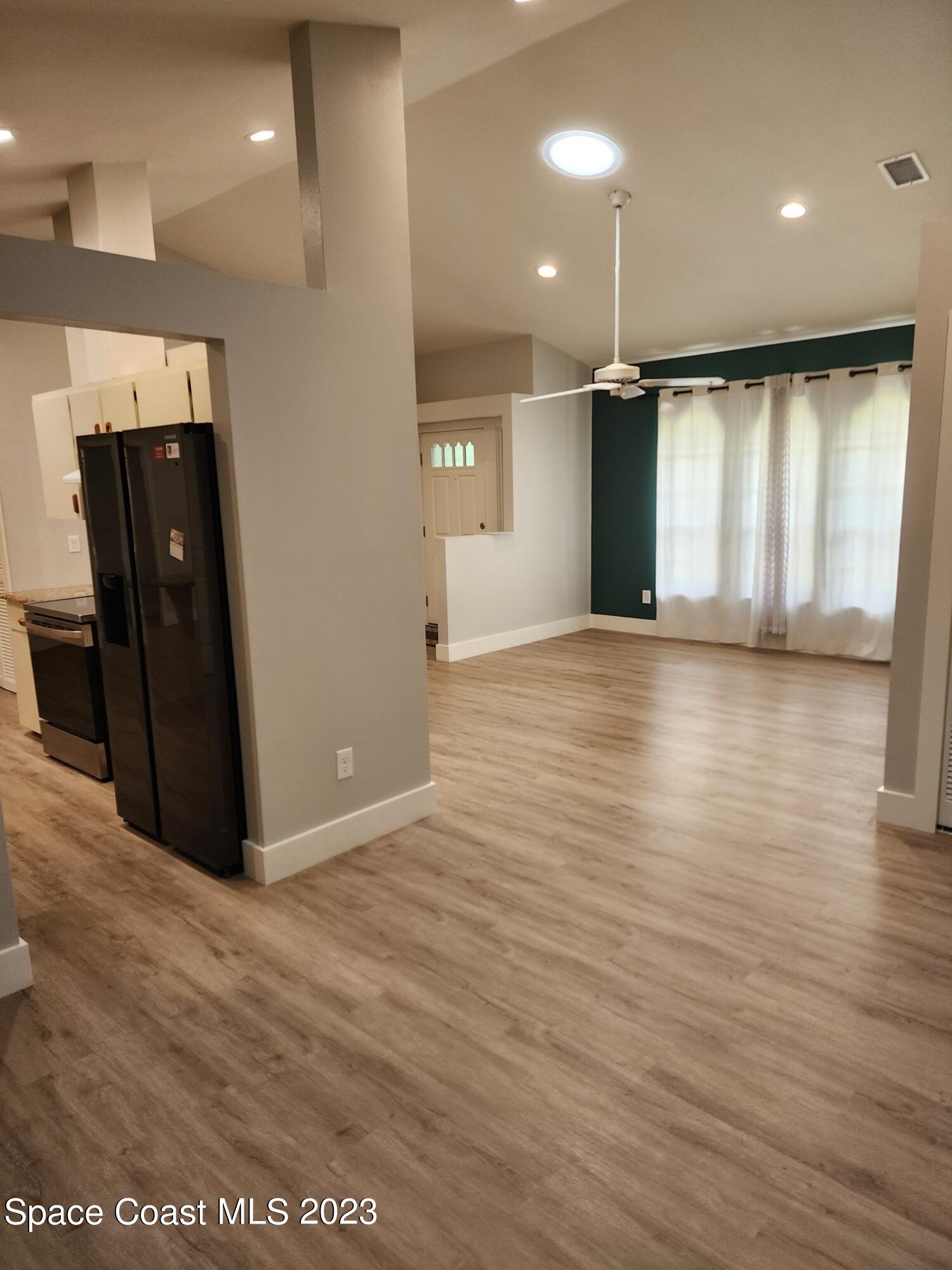 708 Fishtail Palm Boulevard Melbourne, FL 32901 - Photo 15 of 33 a view of an empty room with wooden floor and a window