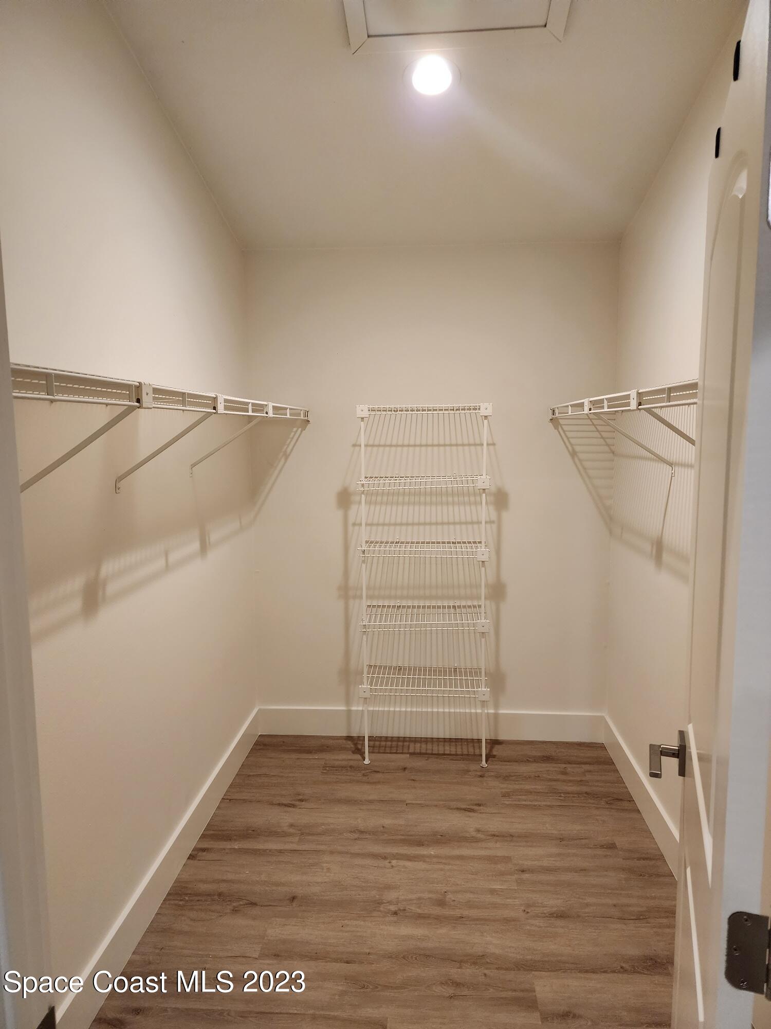 708 Fishtail Palm Boulevard Melbourne, FL 32901 - Photo 22 of 33 a view of walk in closet with empty racks