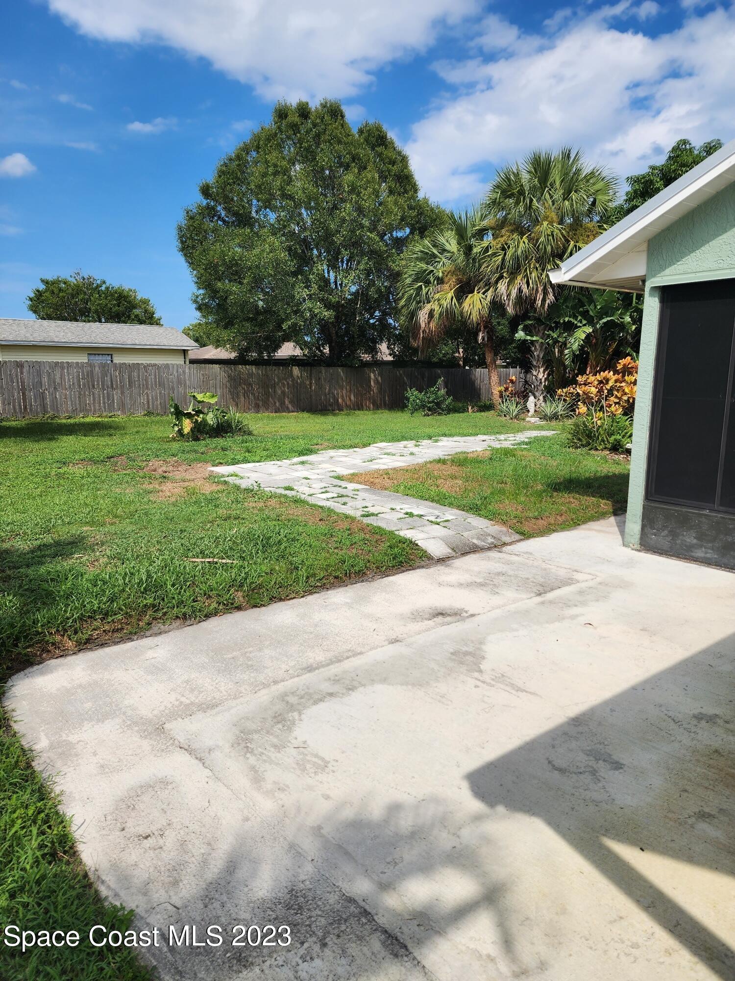 708 Fishtail Palm Boulevard Melbourne, FL 32901 - Photo 27 of 33 a view of a garden with plants and large trees