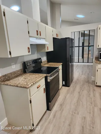 a kitchen with stainless steel appliances a refrigerator sink and stove