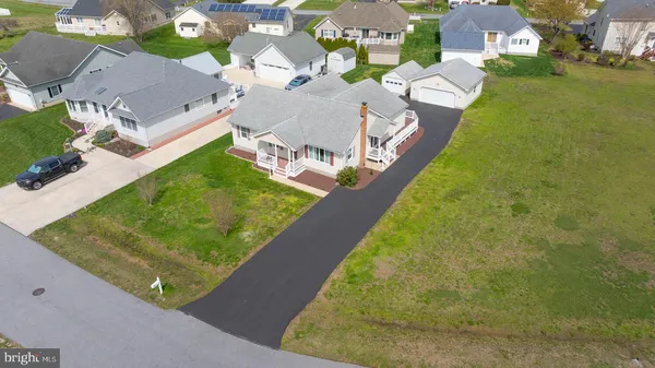 an aerial view of a house with a garden and swimming pool