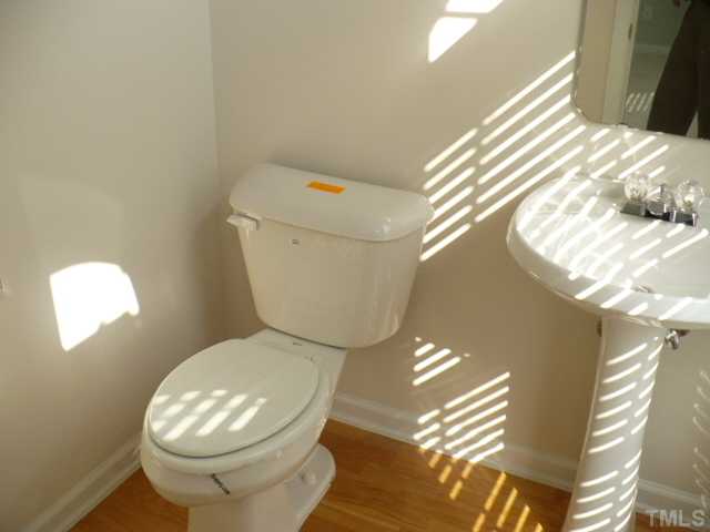 5316 Berry Creek Circle Raleigh, NC 27613 - Photo 6 of 9 a white toilet sitting next to a window