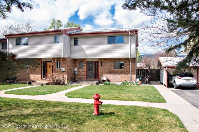 a front view of a house with a yard garage and outdoor seating
