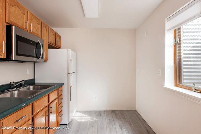 a kitchen with stainless steel appliances granite countertop a sink stove and microwave