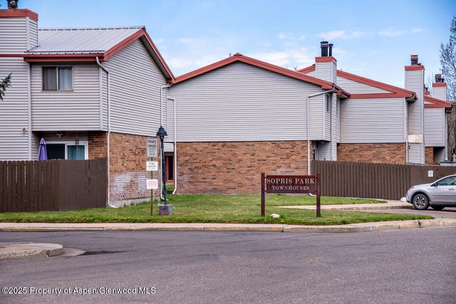 a front view of a house with a garden and plants