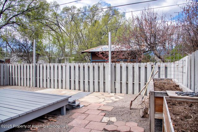 a wooden bench sitting in front of a house