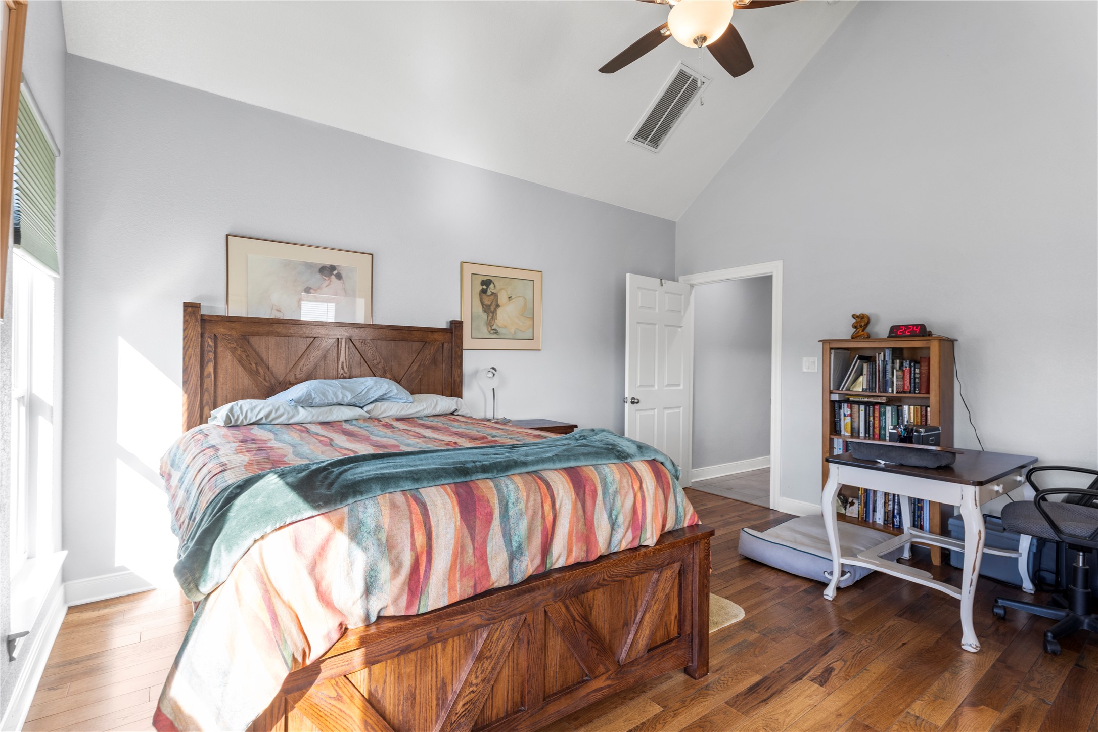 1434 Antioch Road Paige, TX 78659 - Photo 18 of 40 Primary Bedroom featuring lofted ceiling, hardwood flooring, and ceiling fan