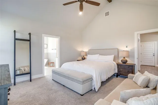 a bedroom with bed and a chandelier