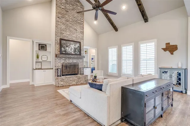 a living room with stainless steel appliances granite countertop furniture and a fireplace