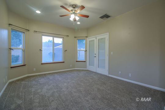 428 Abigail Street Ridgecrest, CA 93555 - Photo 25 of 34 an empty room with windows and fan