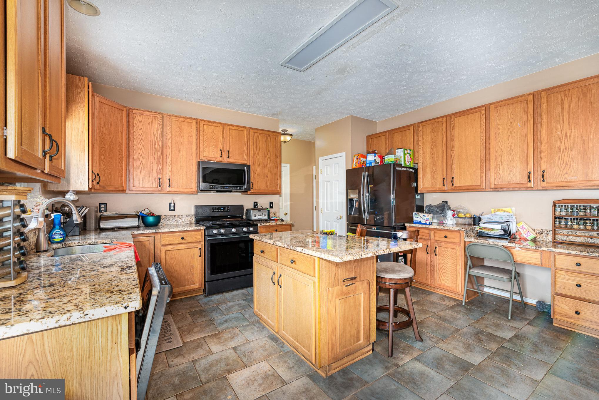 145 West Heather Road Bel Air, MD 21014 - Photo 16 of 47 a kitchen with stainless steel appliances granite countertop a stove top oven a sink dishwasher and a refrigerator