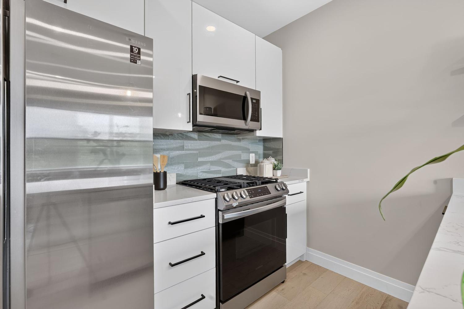 1102 Staples Street Northeast, Unit 301 Washington, DC 20002 - Photo 6 of 23 Sleek kitchen with stylish finishes.