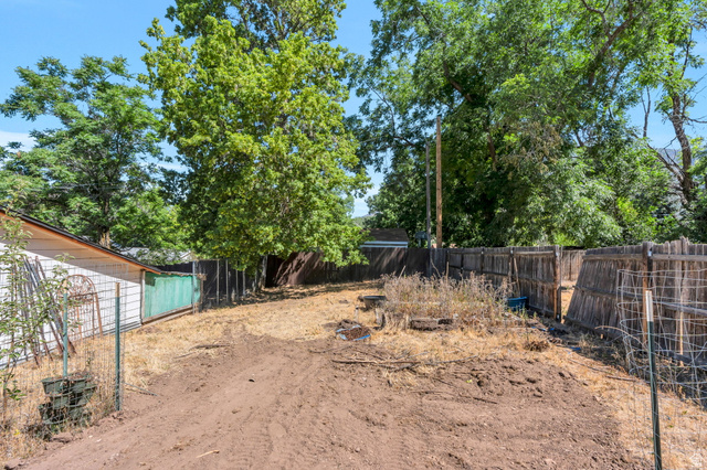 44 North 300 West Springville, UT 84663 - Photo 18 of 24 Expansive yard space with established perimeter fencing, mature trees, and natural ground cover
