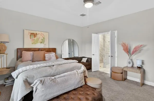 a spacious bedroom with a bed and window