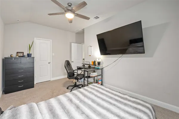 a workspace with a flat screen tv and a window