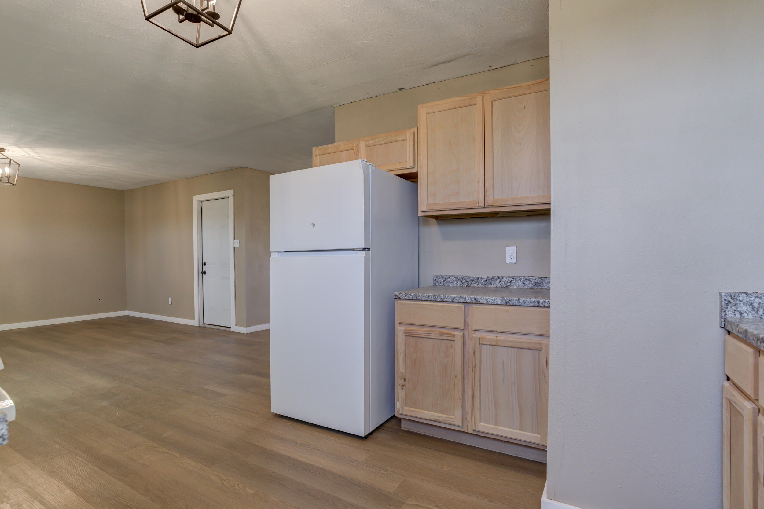 3204 East 2nd Street Lubbock, TX 79403 - Photo 19 of 34 a kitchen with cabinets and refrigerator