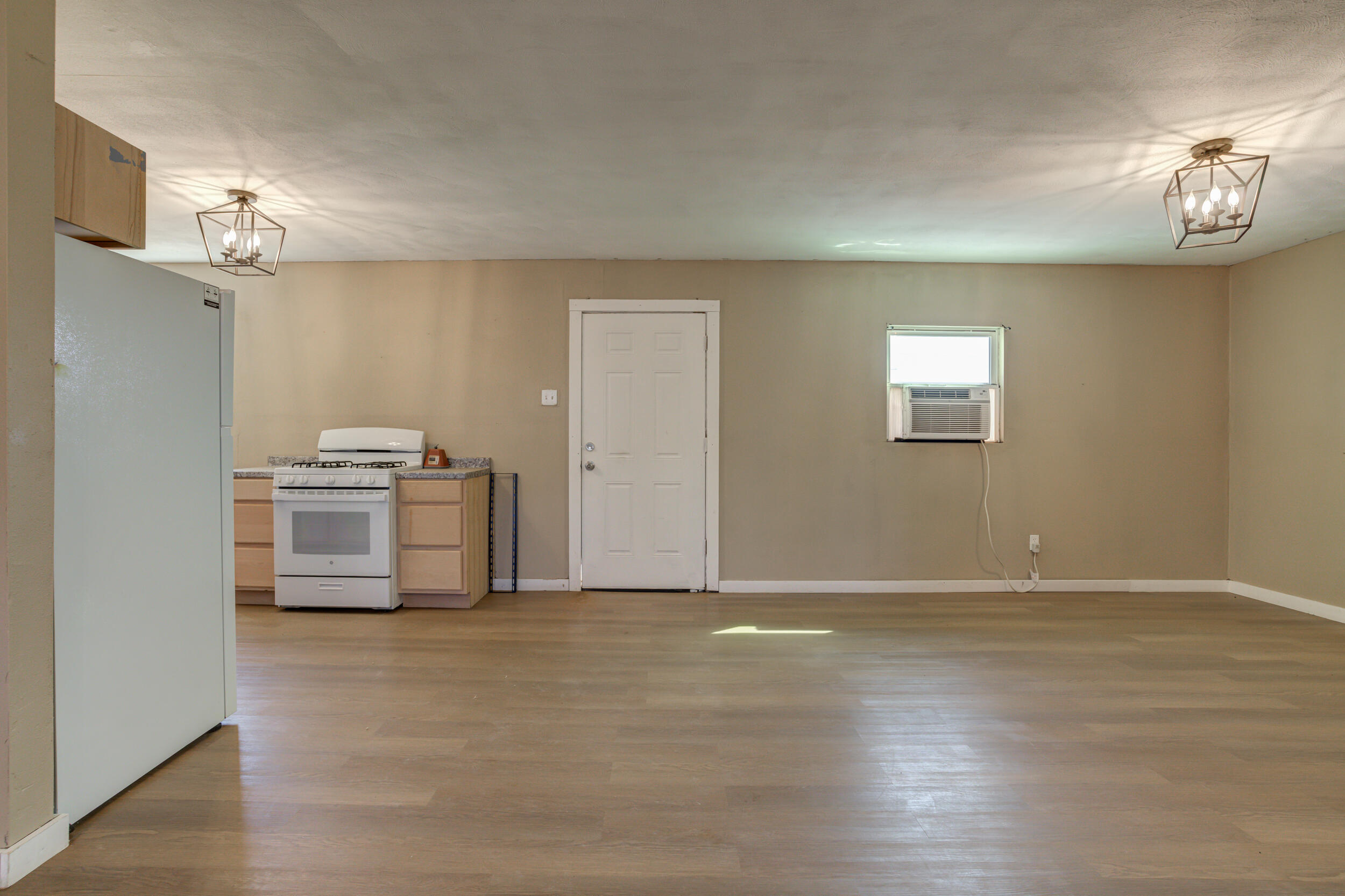 3204 East 2nd Street Lubbock, TX 79403 - Photo 21 of 34 a view of a kitchen with a sink cabinets and a wooden floor
