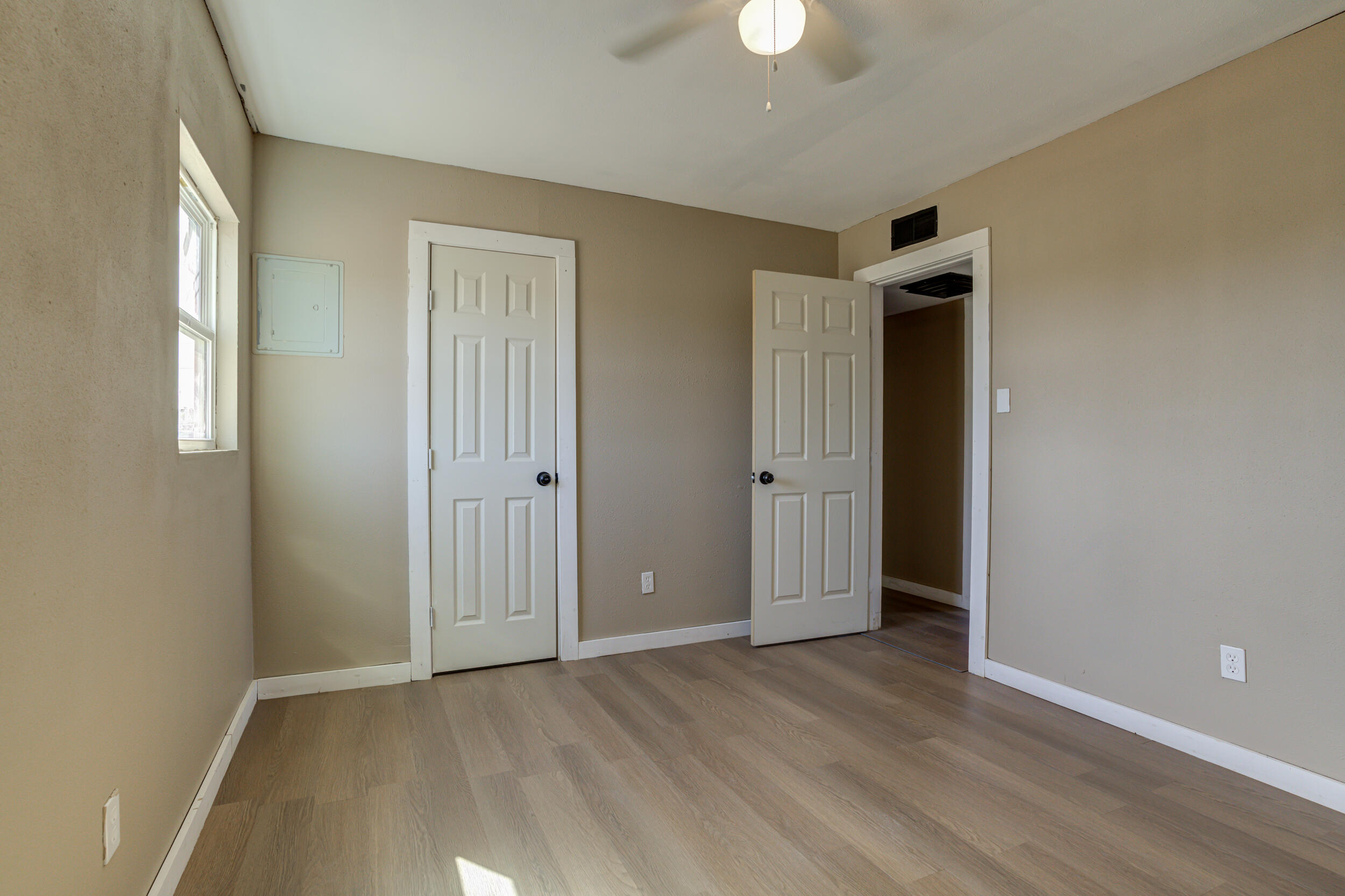 3204 East 2nd Street Lubbock, TX 79403 - Photo 27 of 34 an empty room with wooden floor and windows