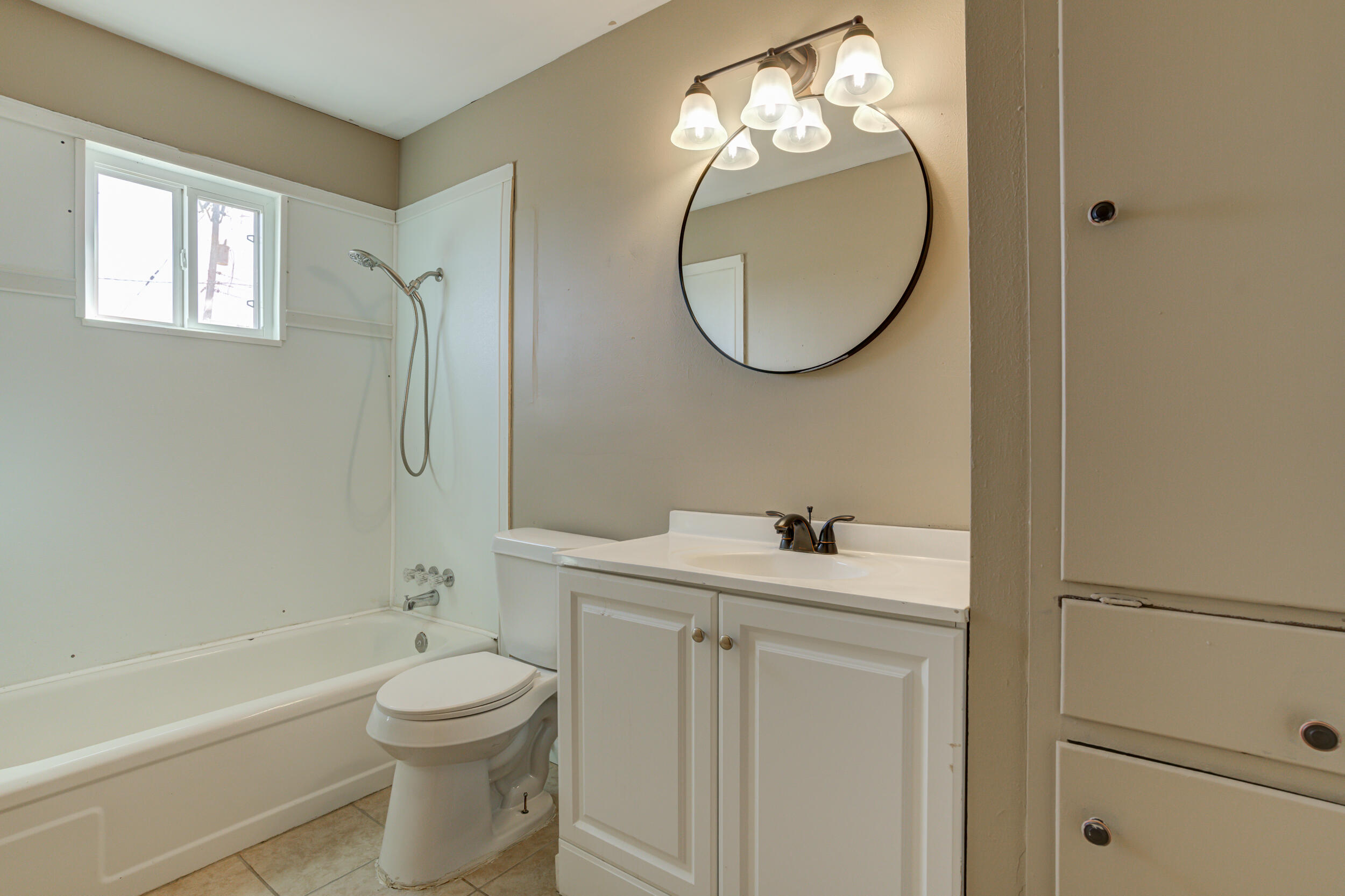 3204 East 2nd Street Lubbock, TX 79403 - Photo 28 of 34 a bathroom with a sink a toilet and a mirror