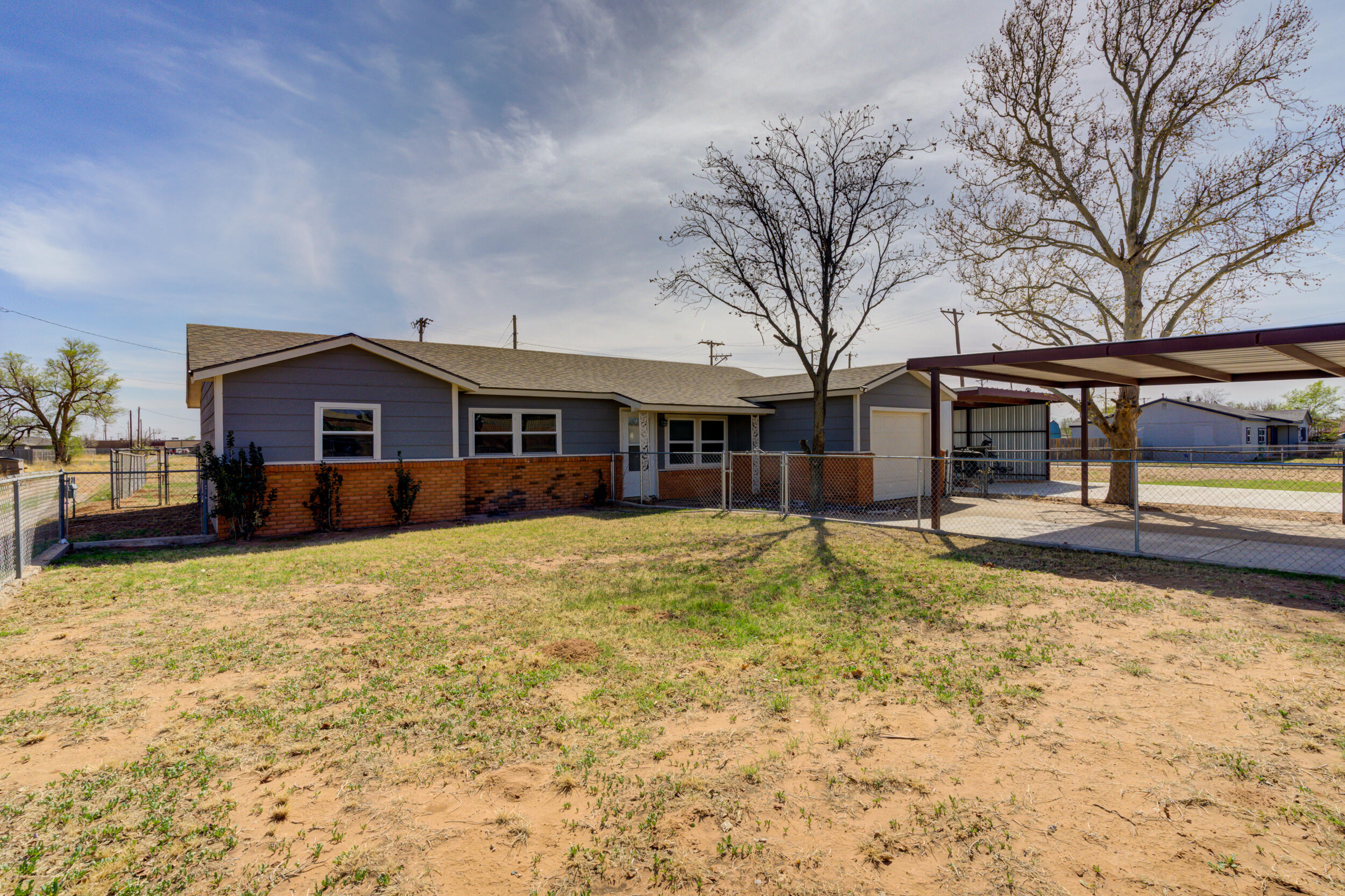3204 East 2nd Street Lubbock, TX 79403 - Photo 3 of 34 a front view of a house with a yard