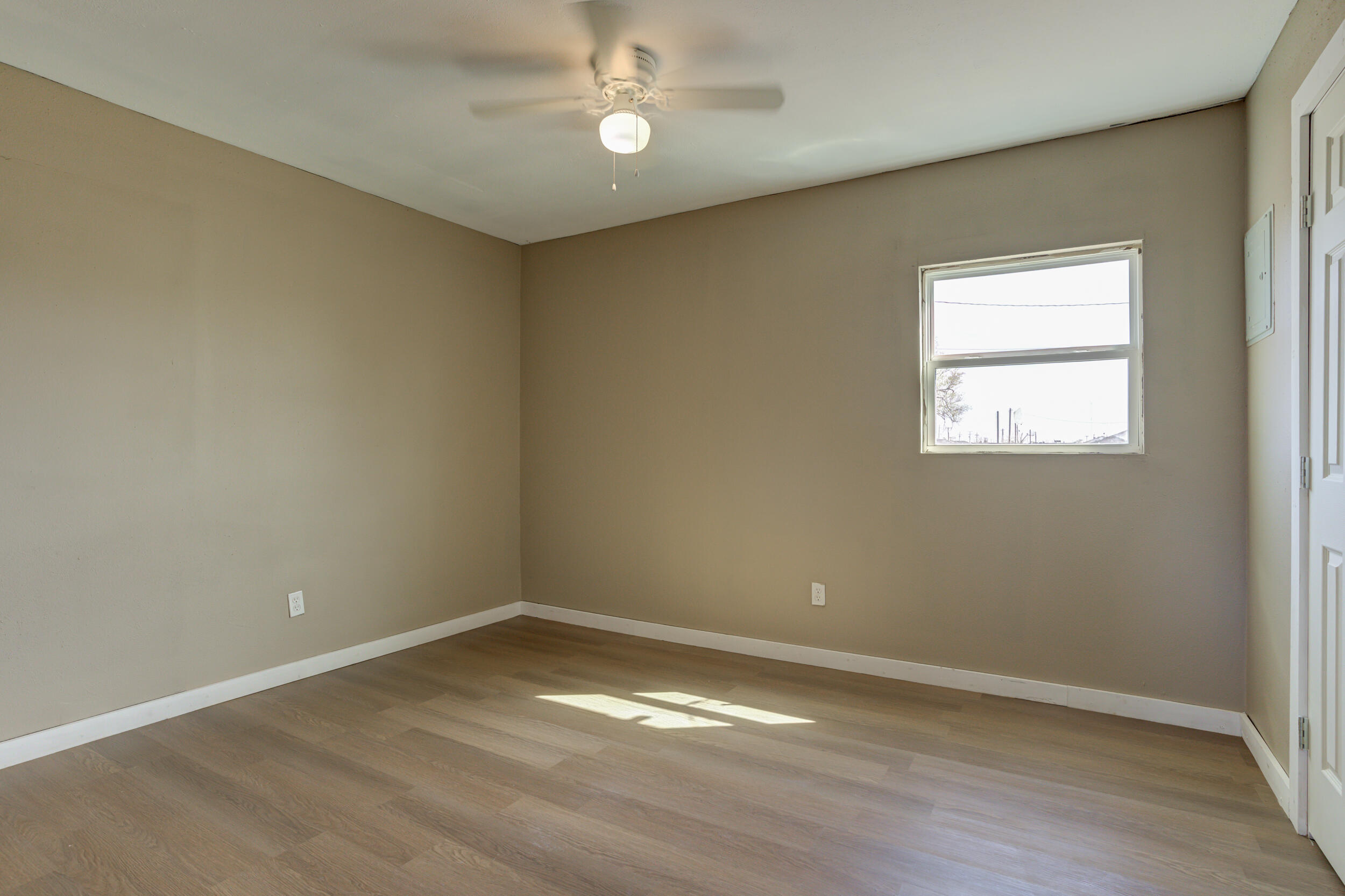 3204 East 2nd Street Lubbock, TX 79403 - Photo 31 of 34 wooden floor in an empty room with a window