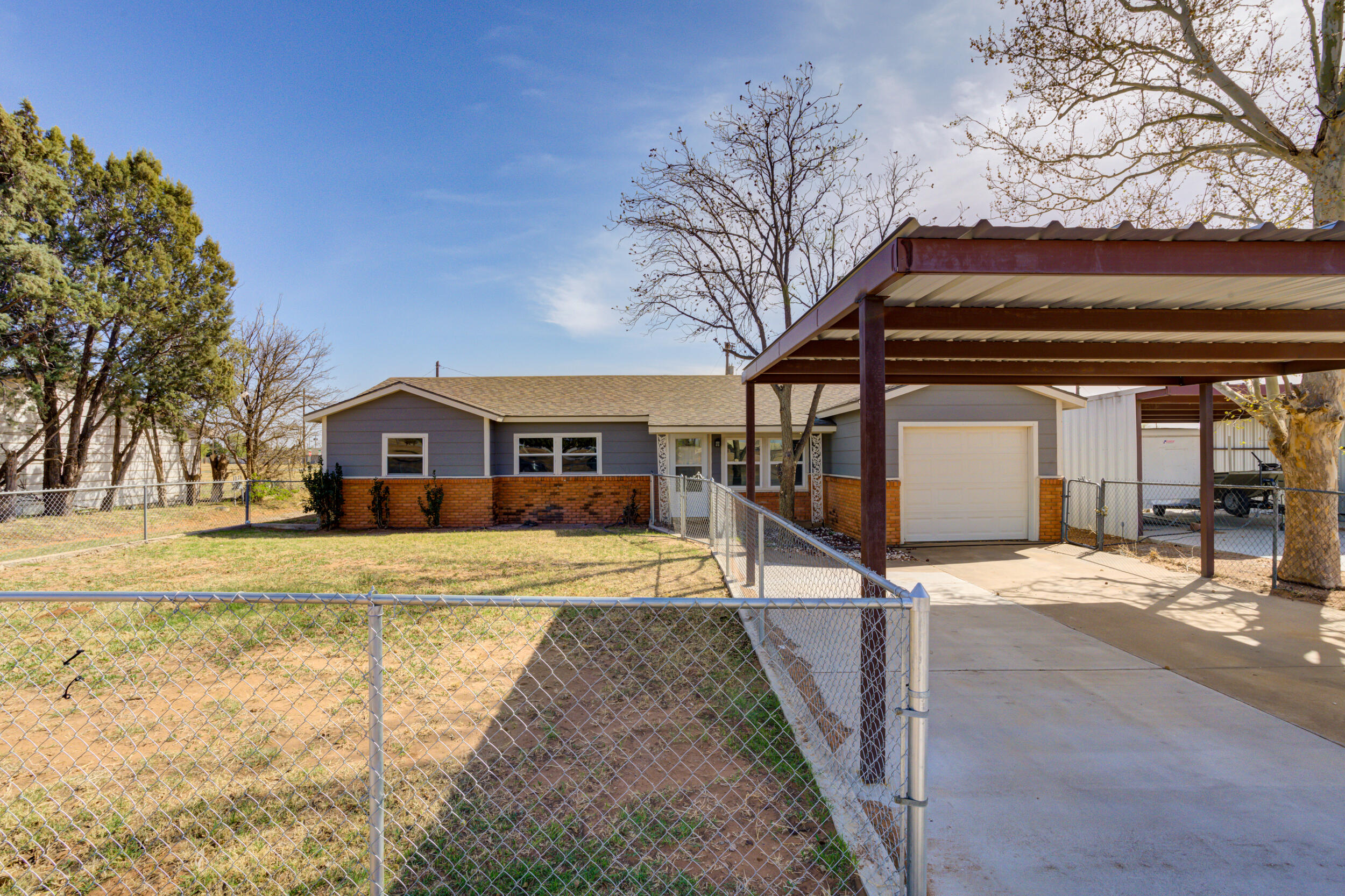 3204 East 2nd Street Lubbock, TX 79403 - Photo 4 of 34 a front view of a house with a yard and garage