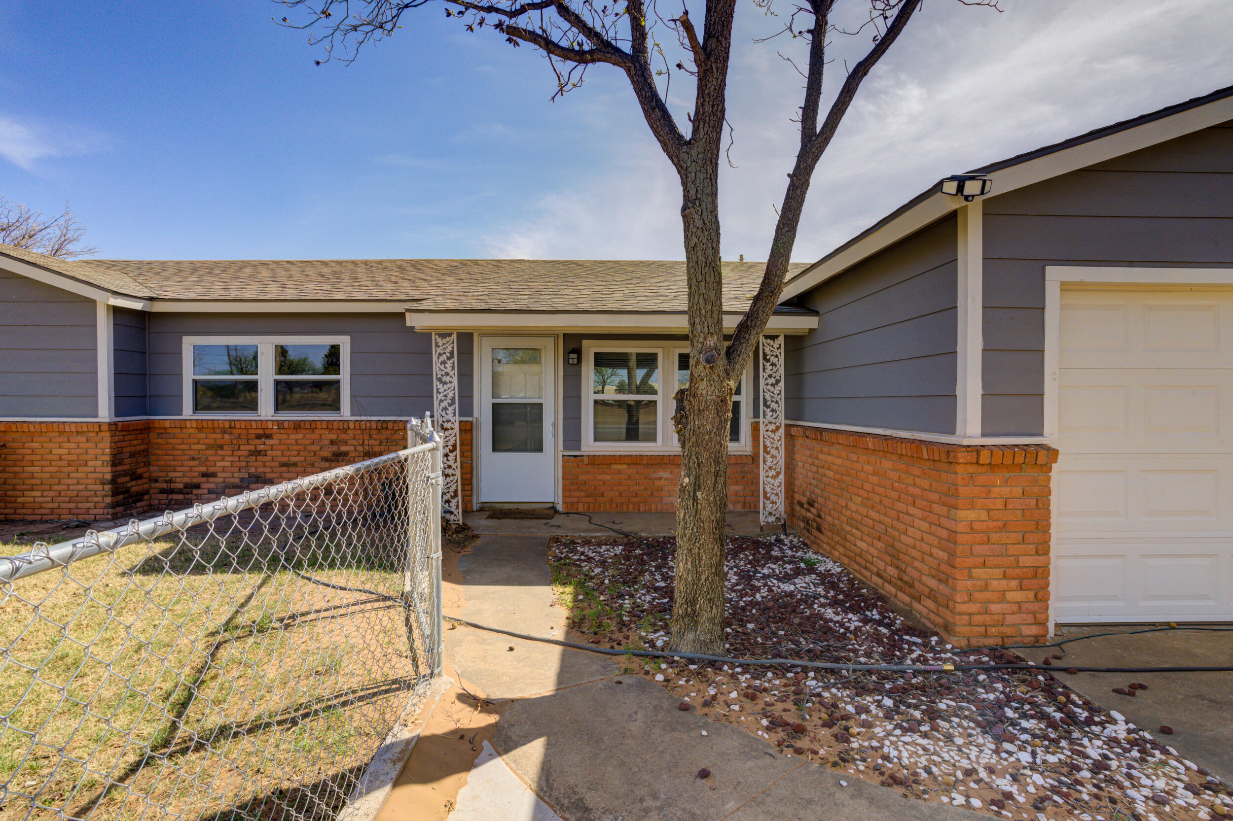 3204 East 2nd Street Lubbock, TX 79403 - Photo 5 of 34 a front view of a house with a yard