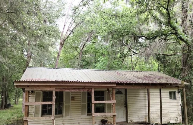 a view of a house with a tree