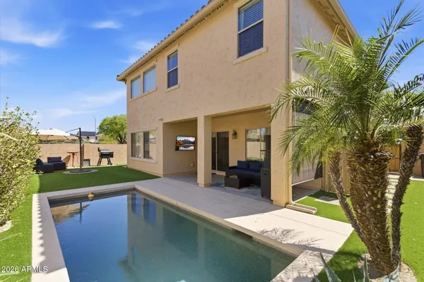 a swimming pool with outdoor seating and yard