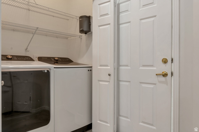 1092 Tithing Ridge Drive Riverton, UT 84065 - Photo 4 of 25 Utility area featuring shelves. Laundry room is immediate from garage entry