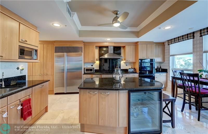 a kitchen with stainless steel appliances granite countertop a stove a sink a microwave and a refrigerator