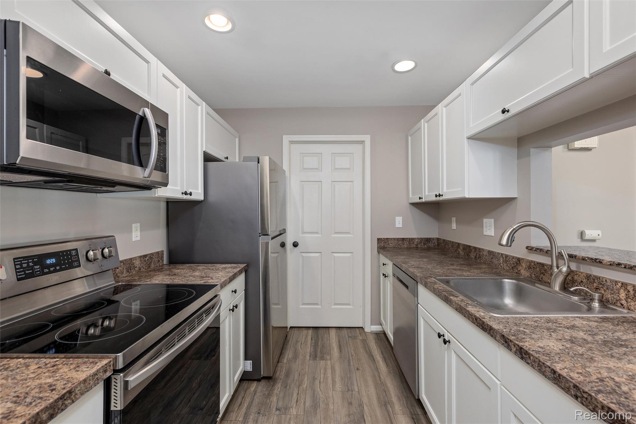 3582 Tremonte Circle Rochester, MI 48306 - Photo 13 of 23 Kitchen featuring stainless steel appliances, white cabinets, new flooring and recessed lighting