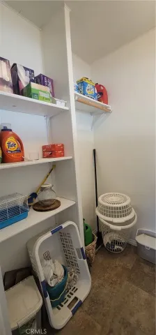 a utility room with a sink a toilet and vanity