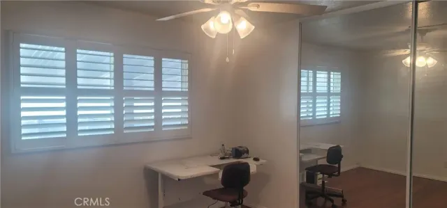 a view of a hallway and a bathroom with wooden floor