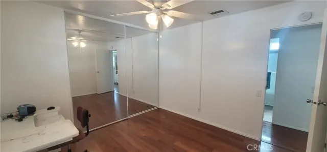 a bedroom with a bed and a dresser next to a window