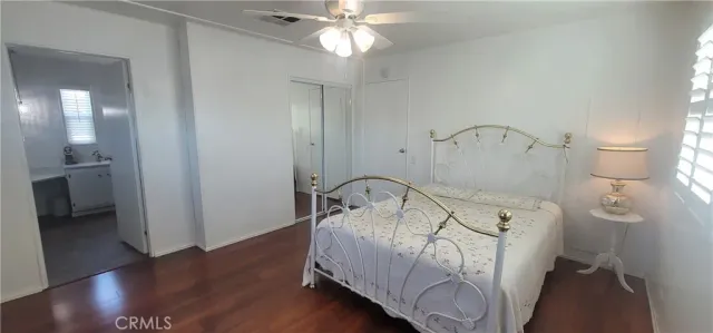 a bed sitting in a spacious bedroom next to a window