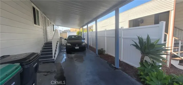 a bedroom with a bed and a dresser next to a window
