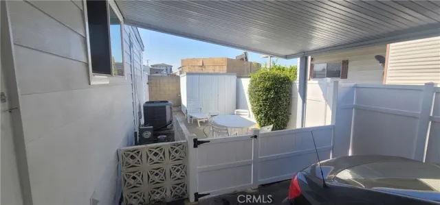 a table and chairs in patio of the house