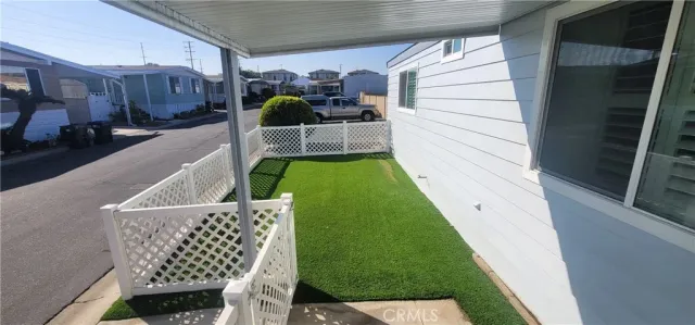 a dining room with furniture and a floor to ceiling window