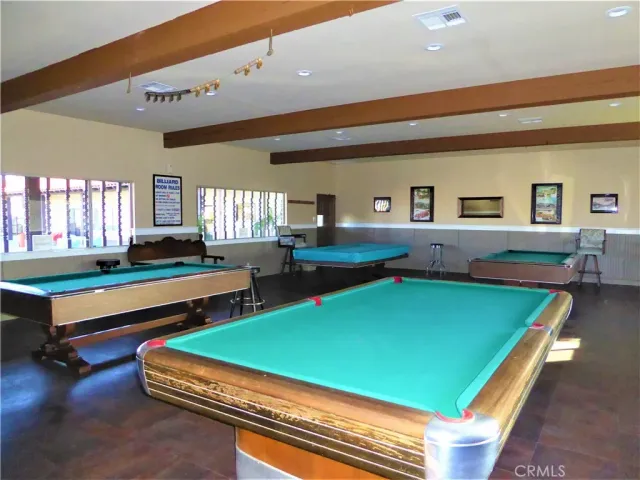 a view of a swimming pool with lawn chairs