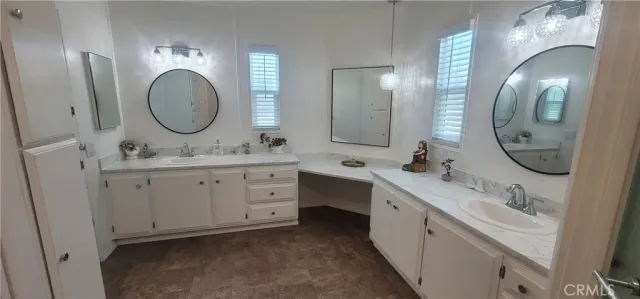 a spacious bathroom with a double vanity sink double and mirror